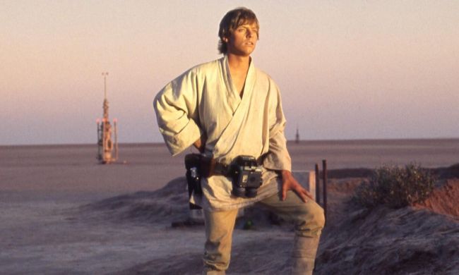 Luke looks at the sunset in Star Wars.
