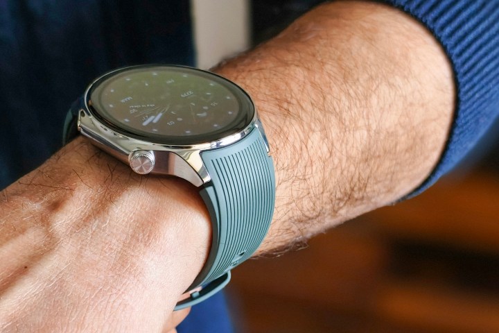Person wearing OnePlus Watch 2 with a green strap on their wrist.