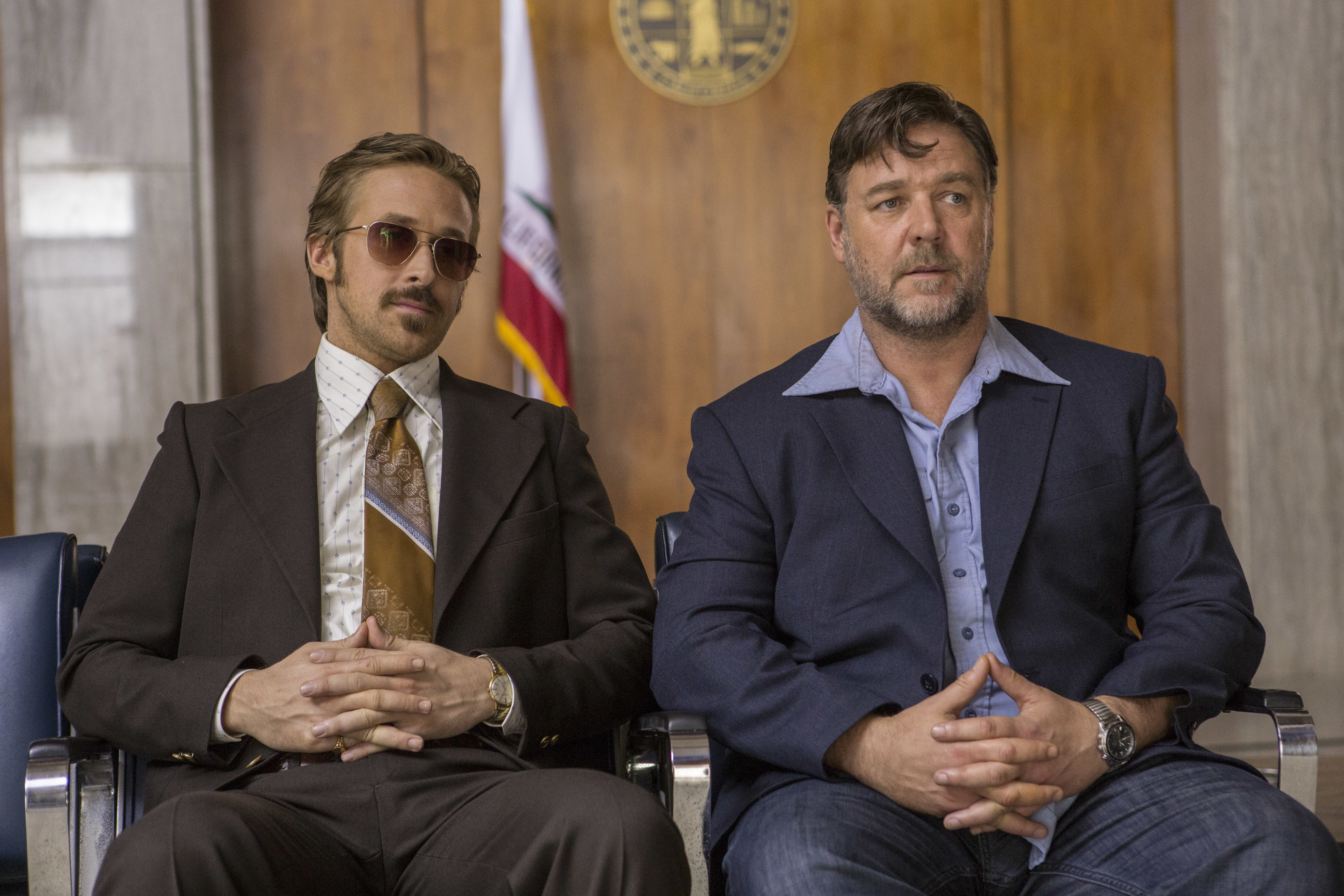 Ryan Gosling and Russell Crowe sit together in The Nice Guys.