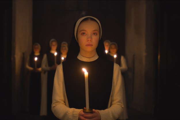 Sydney Sweeney holds a candle in Immaculate.