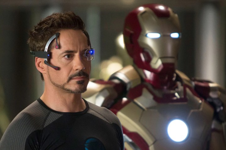 Tony Stark stands near an Iron Man suit in Iron Man 3.