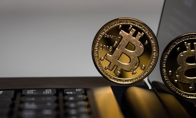 Faux bitcoin coin on a laptop.
