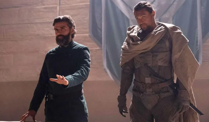 Two men stand next to each other in Dune.