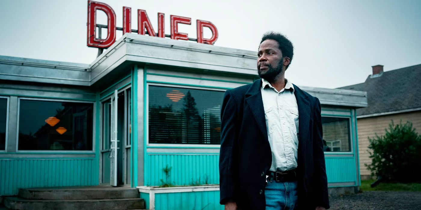 A man stands outside a diner in From.