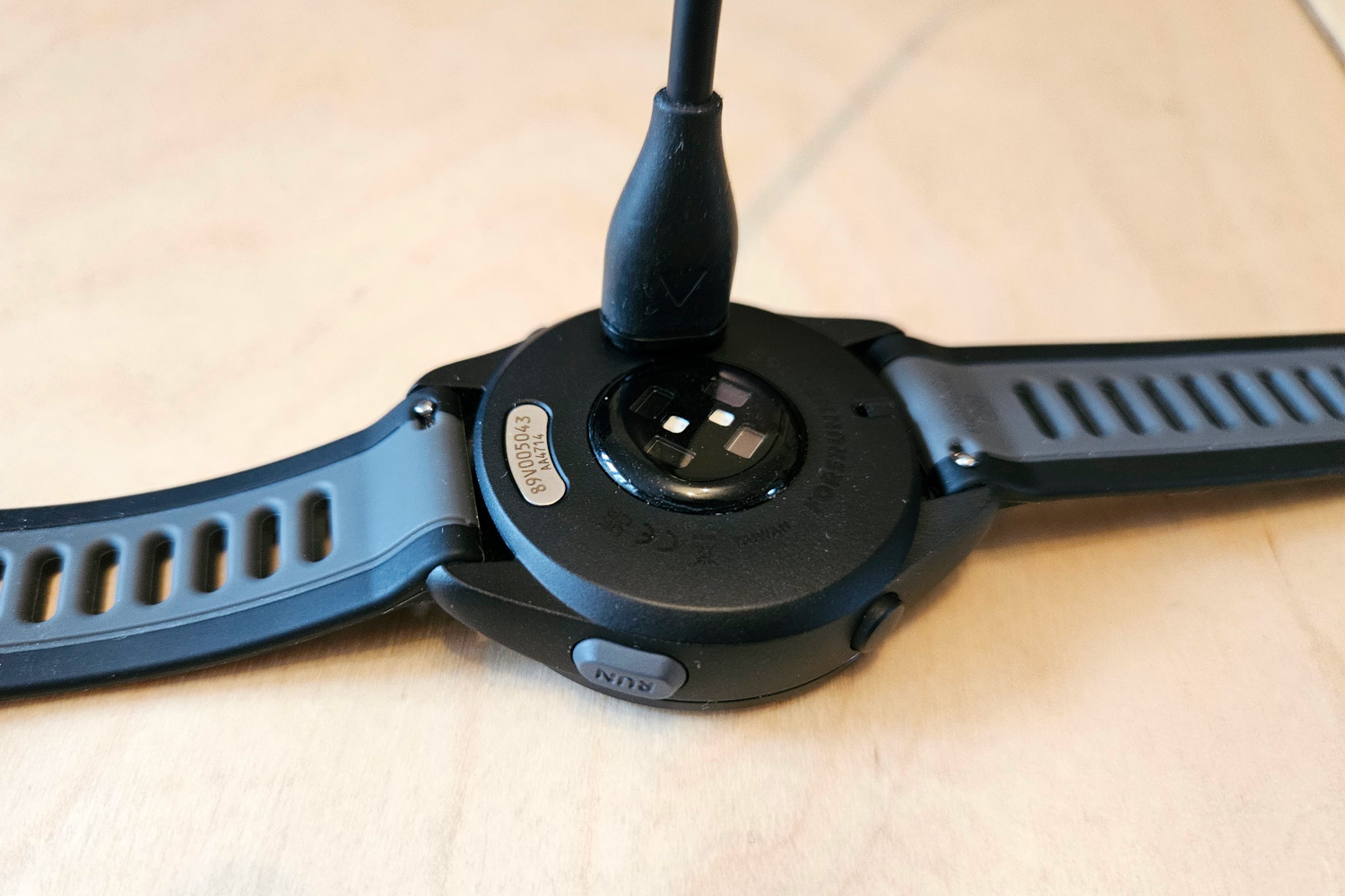The Garmin Forerunner 165 Music being charged.
