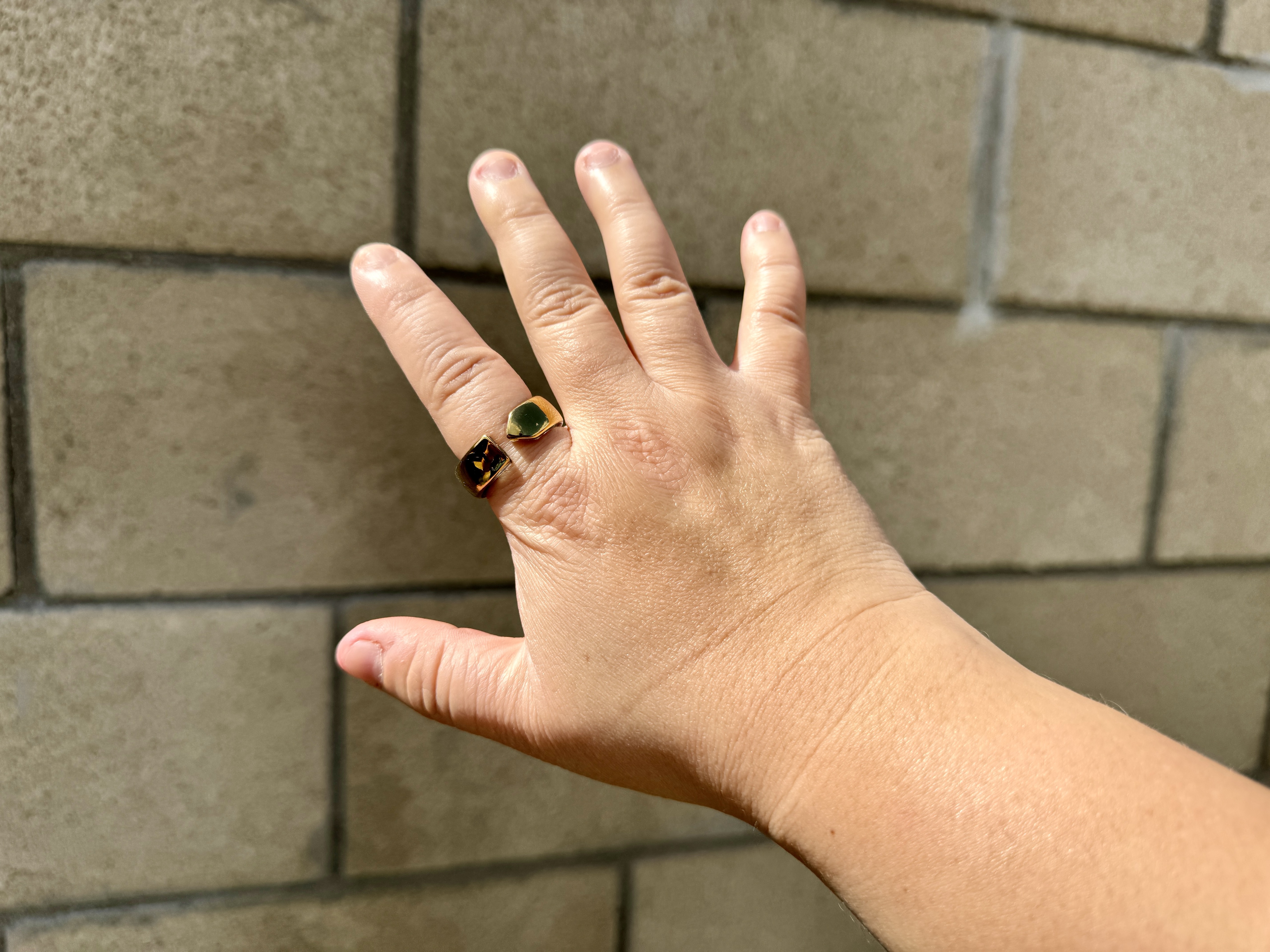 Movano Evie Ring in gold worn on index finger.