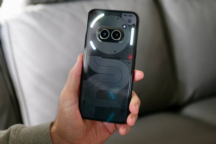 A person holding the Nothing Phone 2a, showing the Glyph Lights.