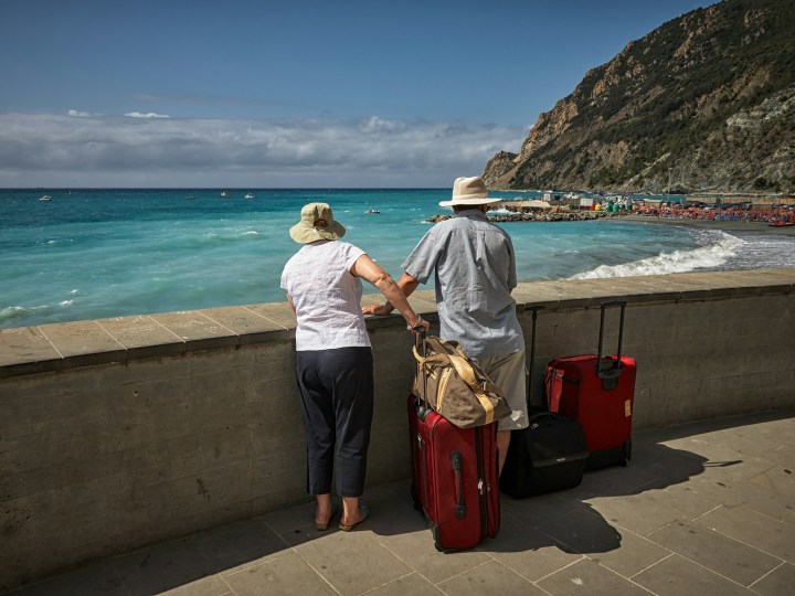 Older couple looking at beautiful coastal views while traveling.