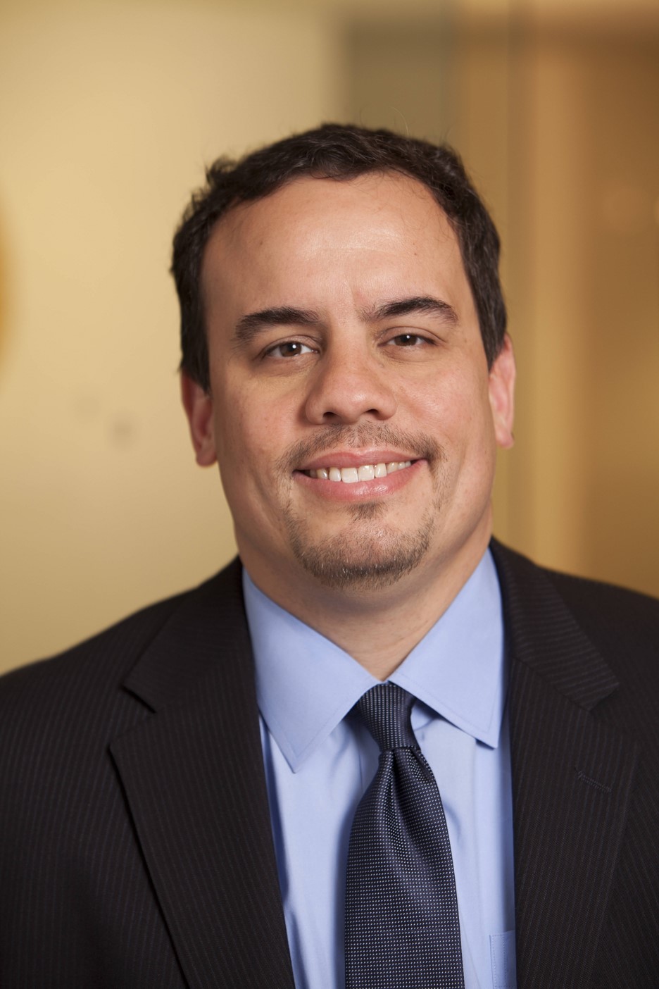 A headshot shows Ray Rodriguez in a suit.