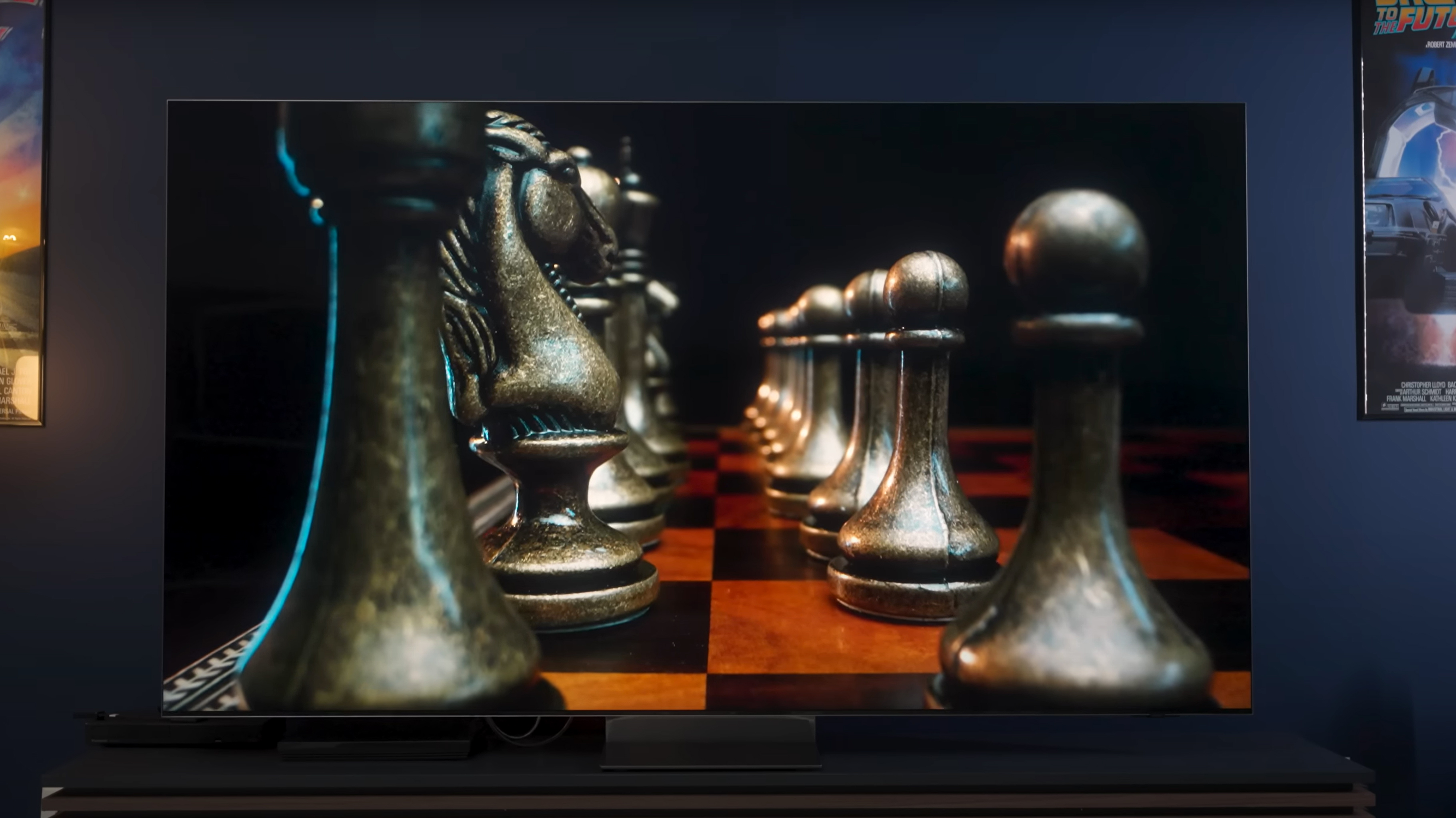 A closeup view of two ranks of chess pieces on a board shown on a Samsung QN900D.