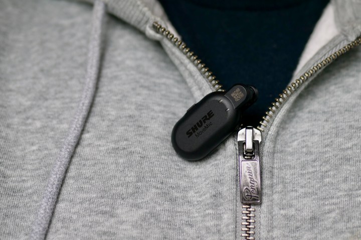 A person wearing a Shure MoveMic microphone.