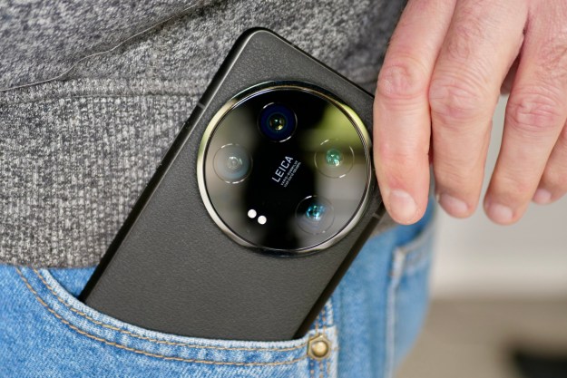 A person taking the Xiaomi 14 Ultra out of a pocket.