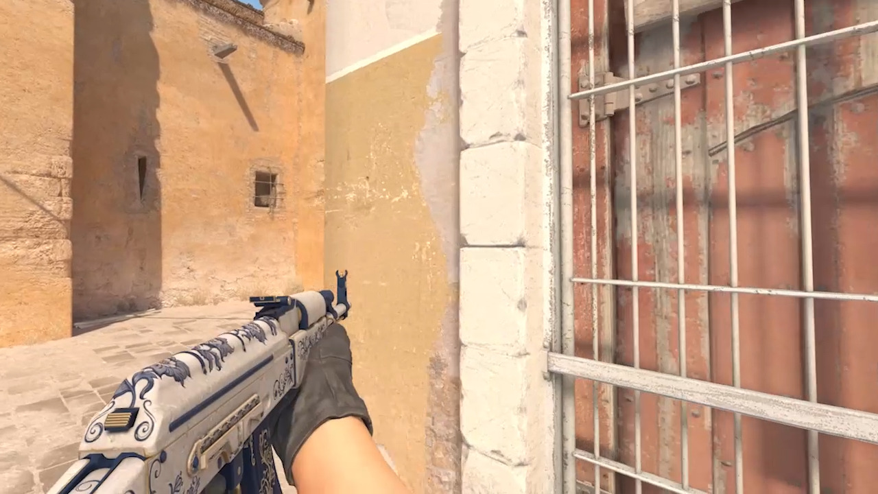 A character holding a gun in the left hand in Counter Strike 2.