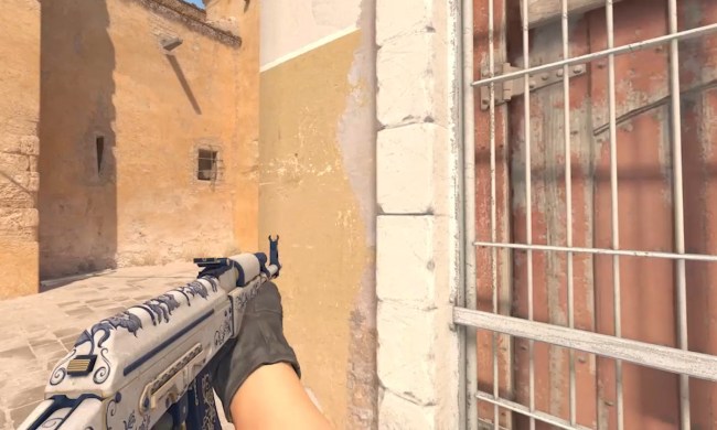 A character holding a gun in the left hand in Counter Strike 2.