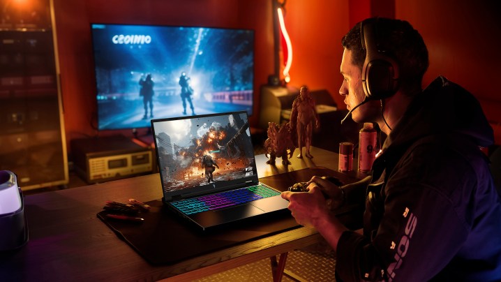 A person gaming on the new Acer Nitro 16 gaming laptop placed on a desk.