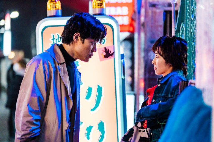 A man looks down at a woman in City Hunter.