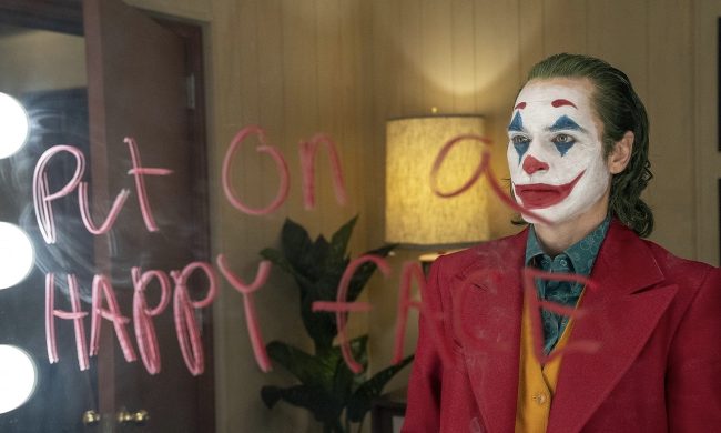 A clown stares into the mirror.