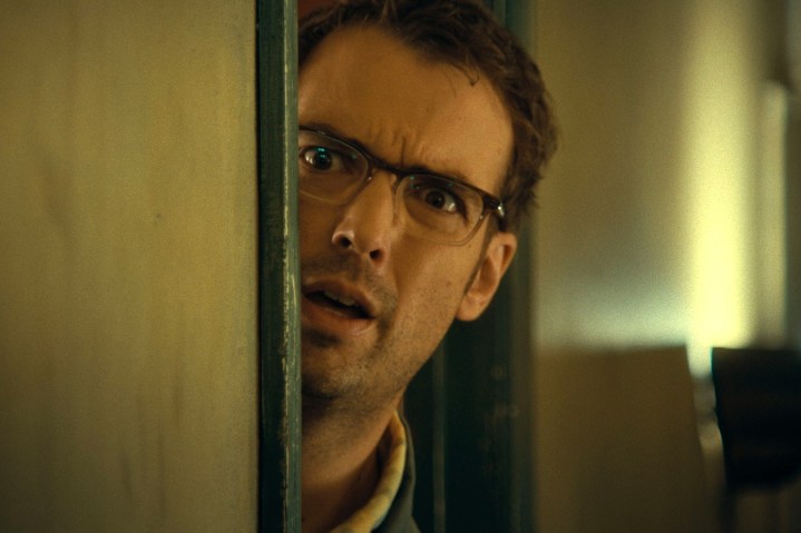 Jonah Ray peers out a doorway in Destroy All Neighbors.