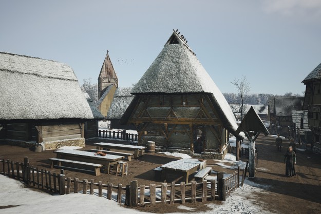 A snowy settlement in Manor Lords.