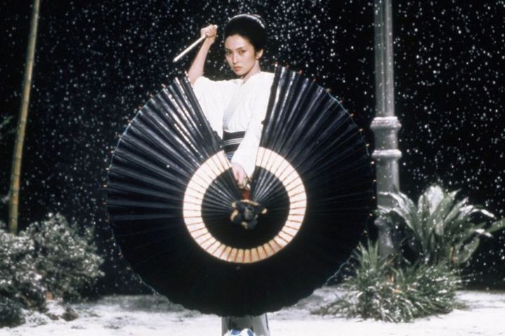 Meiko Kaji holding a knife and umbrella in Lady Snowblood.