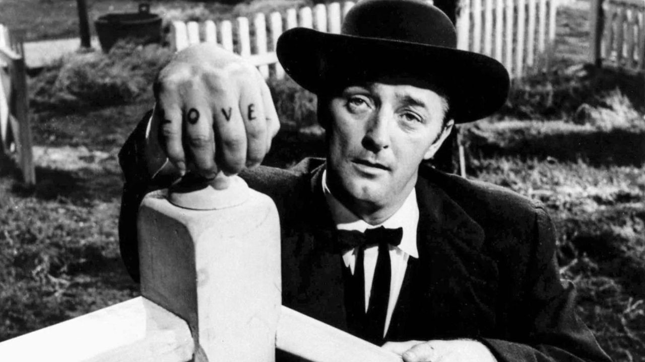 Robert Mitchum as Reverend Harry Powell showing his hand with the word "LOVE" tattoed on his fingers in The Night of the Hunter.