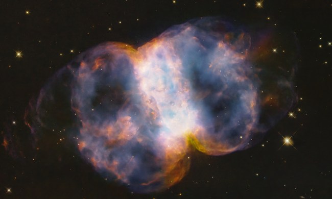 In celebration of the 34th anniversary of the launch of NASA’s legendary Hubble Space Telescope, astronomers took a snapshot of the Little Dumbbell Nebula, also known as Messier 76, or M76, located 3,400 light-years away in the northern circumpolar constellation Perseus. The name 'Little Dumbbell' comes from its shape that is a two-lobed structure of colorful, mottled, glowing gases resembling a balloon that’s been pinched around a middle waist. Like an inflating balloon, the lobes are expanding into space from a dying star seen as a white dot in the center. Blistering ultraviolet radiation from the super-hot star is causing the gases to glow. The red color is from nitrogen, and blue is from oxygen.