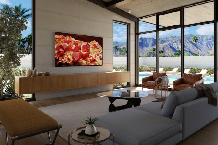 The Sony Bravia XR X93L 4K Google TV hanging over a media center in a living room.