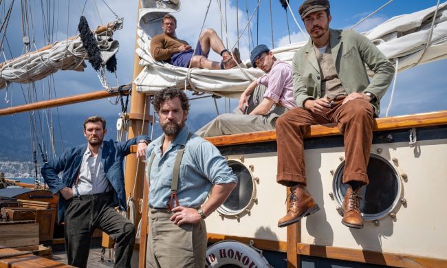 The cast of The Ministry of Ungentlemanly Warfare sit and stand on a boat together.