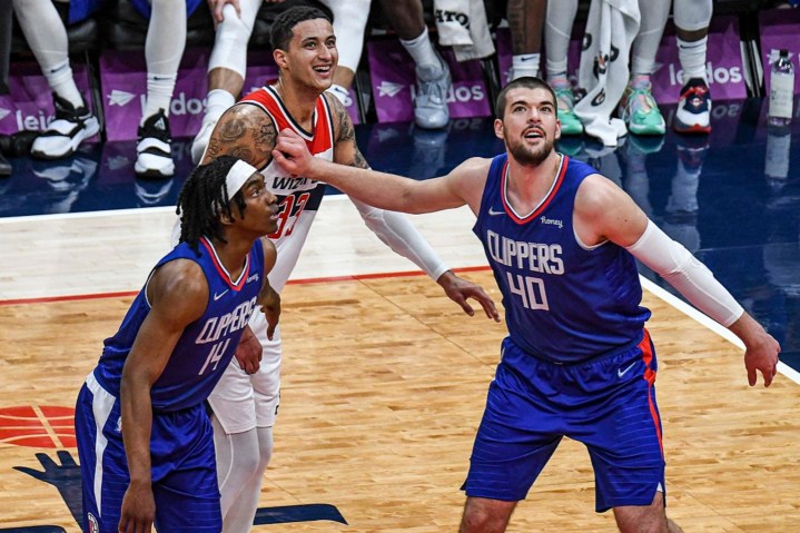 Two Clippers' players go to box out a Wizard player.