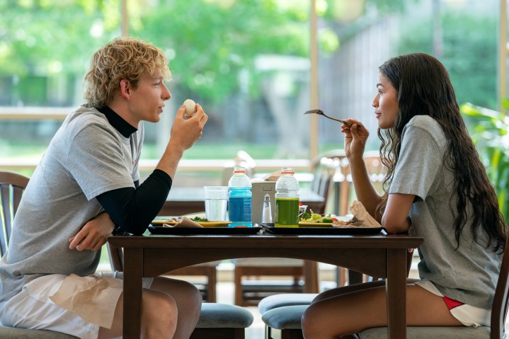 Zendaya sits across a table from Mike Faist in Challengers.