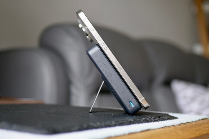 The iPhone 15 Pro Max being charged by the Anker MagGo Power Bank.