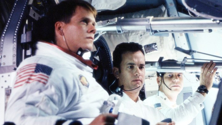 Three astronauts sit in a space ship in Apollo 13.