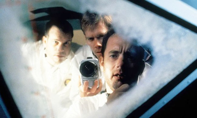 Three astronauts look out of their space ship in Apollo 13.