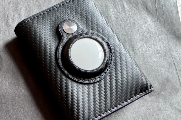 An Apple AirTag in a black wallet.