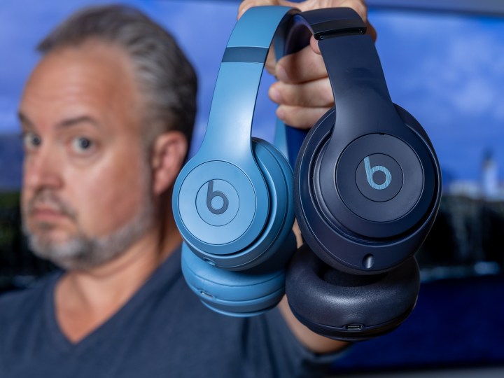 Phil Nickinson holding the Beats Solo 4 and the Beats Studio Pro headphones.
