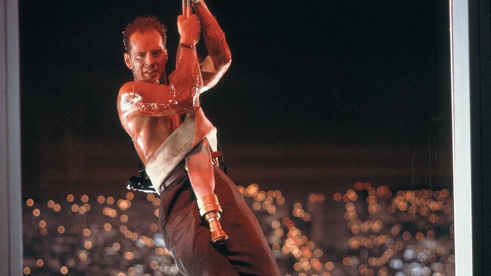 Bruce WIllis swings to the rescue in Die Hard.