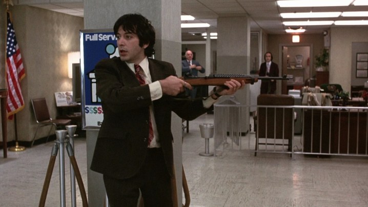 A man with a gun robs a bank in Dog Day Afternoon.