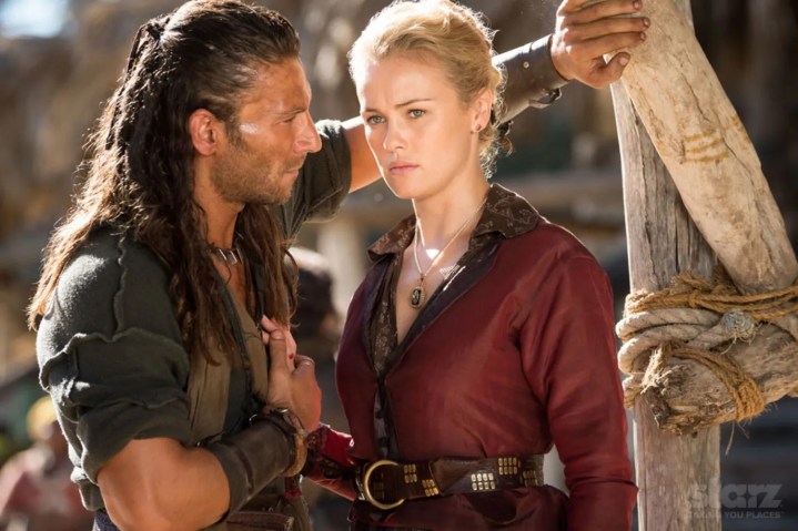 A man stands close to a woman in Black Sails.