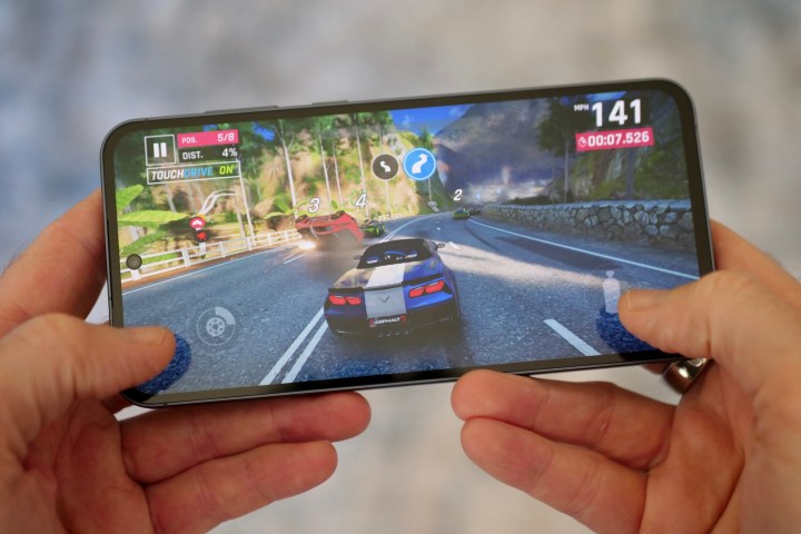 A person playing a game on the Samsung Galaxy A55.