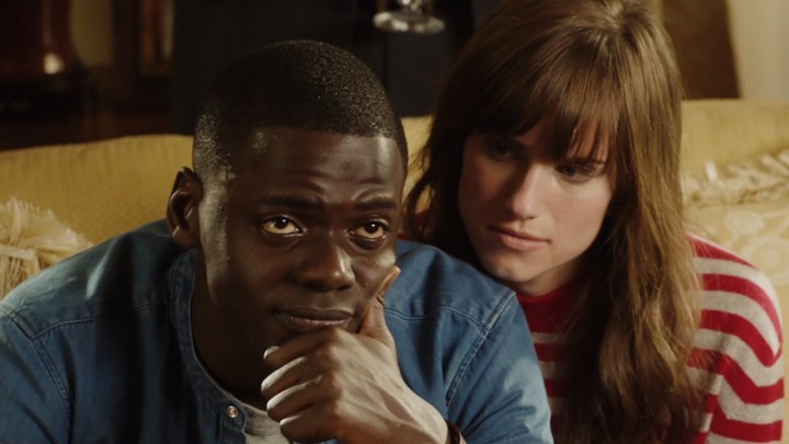 Chris looking worries, Rose comforting him in a scene from Get Out.