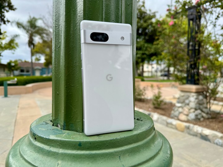 Google Pixel 7a in Snow leaning on lamp post.
