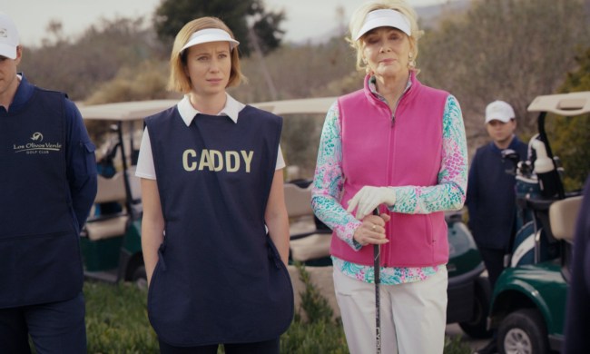 Jean Smart stands next to a caddy on a golf course in Hacks.