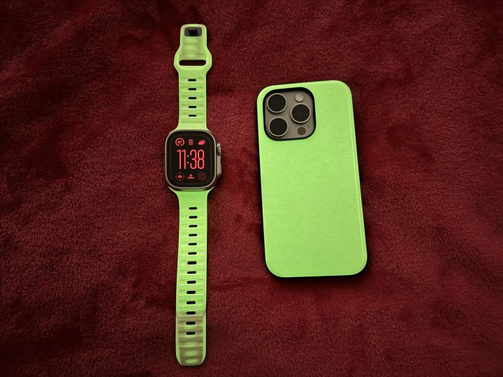 Nomad Glow 2.0 Sport Case and Apple Watch Sport Band in a dark room.