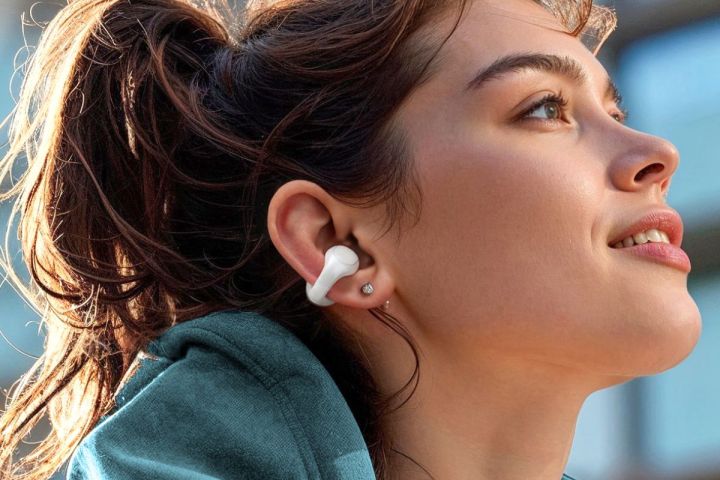 Woman wearing Soundcore C30i clip-style open earbuds.