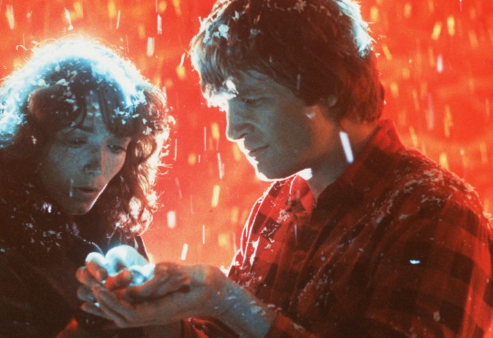 A man and a woman look at snowflakes in Starman.