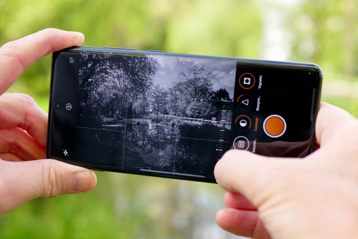 A person taking a photo with the OnePlus 12.