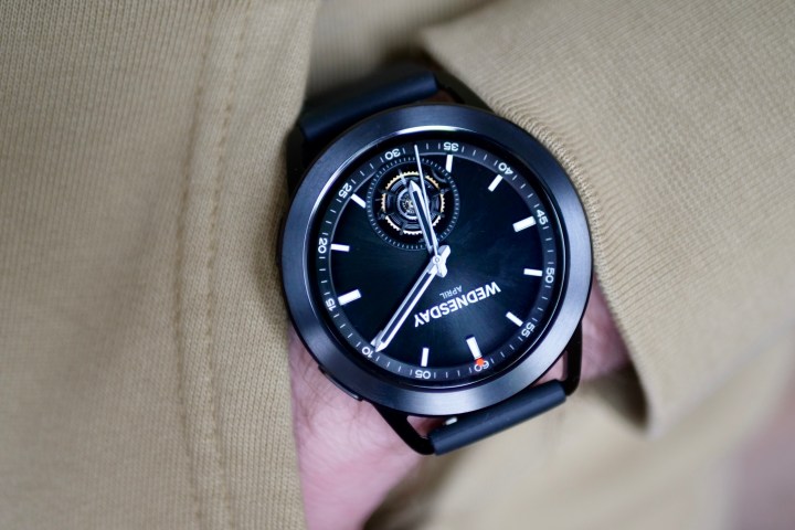 A person wearing the Xiaomi Watch S3 with a black strap and bezel.