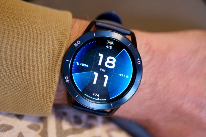 A person wearing the Xiaomi Watch S3 with a blue strap and bezel.