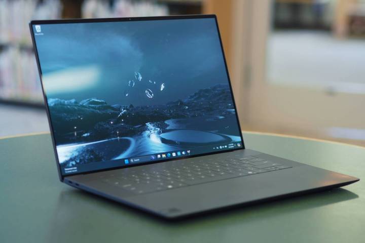 The XPS 16 sits open on a table.