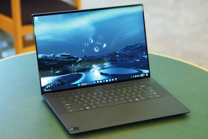 The XPS 16 sits open on a table.